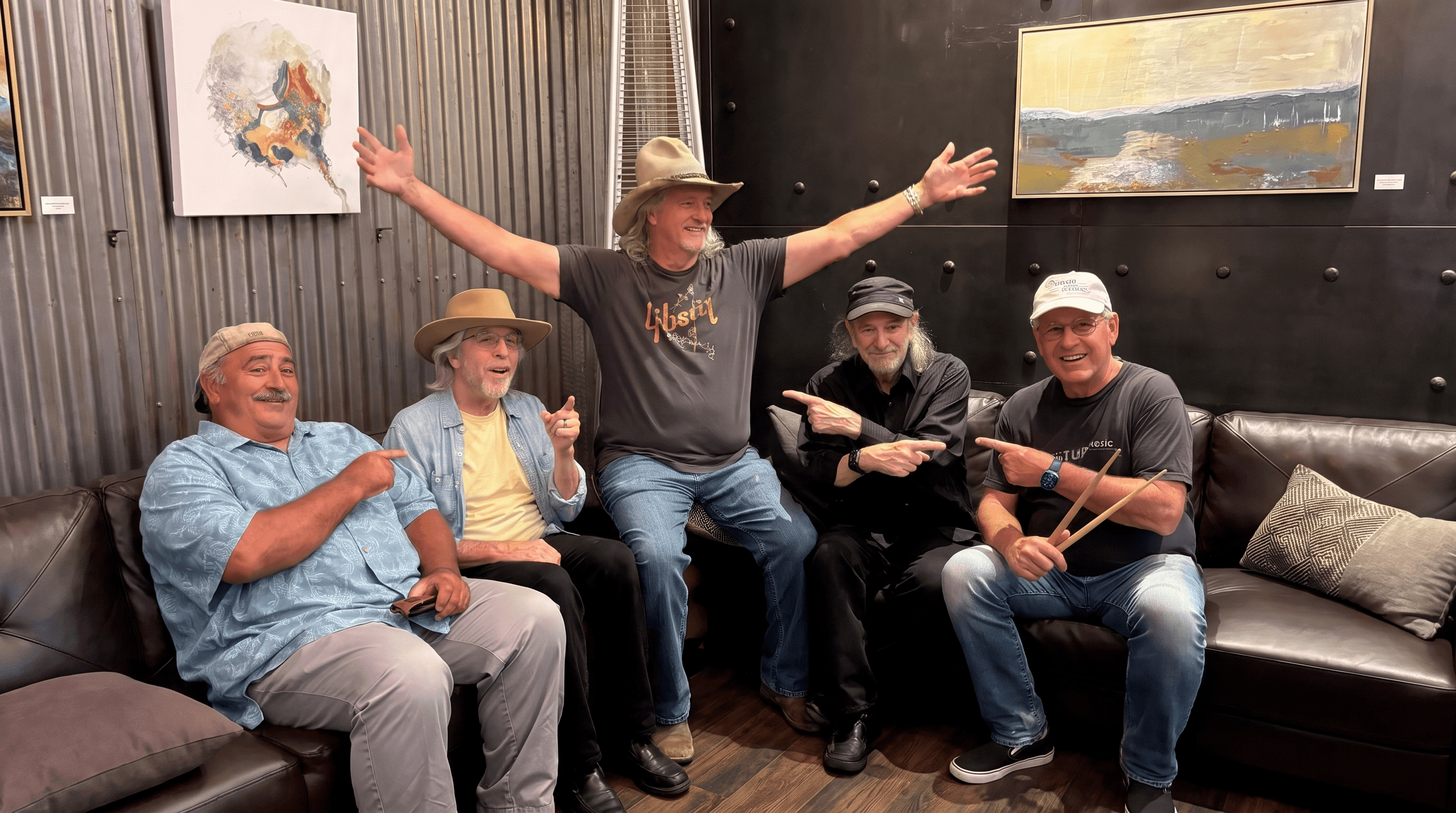 Five American Underdog band members relaxing together indoors
